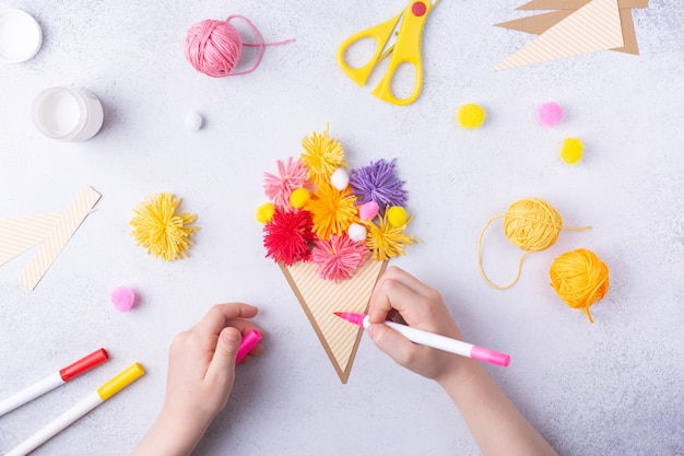 Foto mestieri di carta per la festa della mamma marzo o compleanno bambino piccolo che fa un mazzo di fiori di carta colorata e palline colorate per maglieria per la mamma semplice idea regalo vista dall'alto spazio copia foto di alta qualità