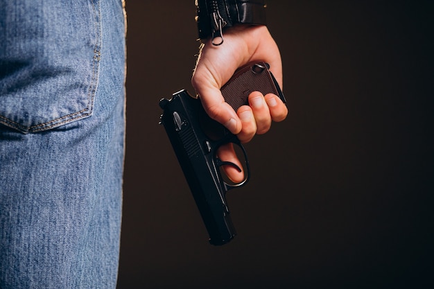 Foto grátis ator de homem bonito posando em estúdio com arma