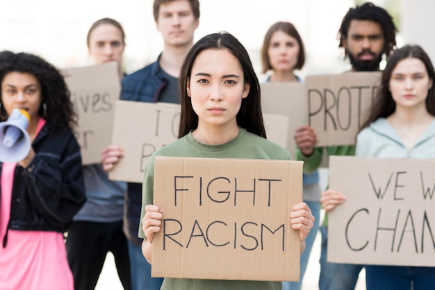 Foto grátis grupo de pessoas com citações de luta contra o racismo