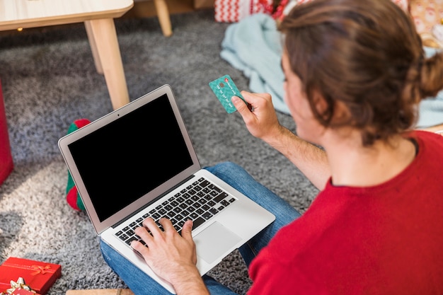 Homem, com, cartão crédito, usando computador portátil