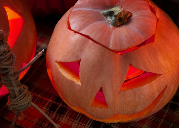 Foto grátis lanterna de abóbora esculpida de halloween assustador com estatueta feita de paus