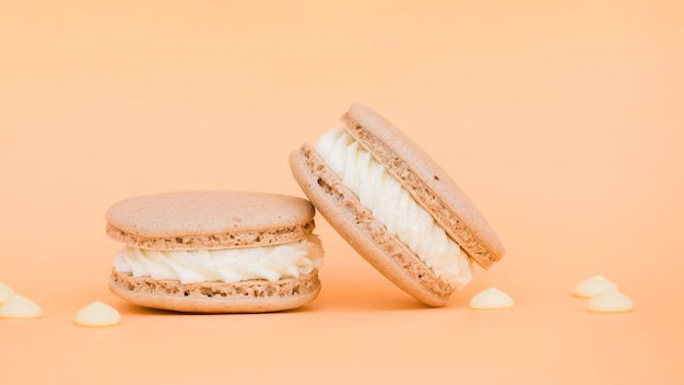 Foto grátis macaroons deliciosos cremosos no contexto bege