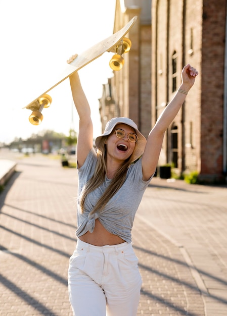 Foto grátis médio, tiro, mulher segura, skateboard