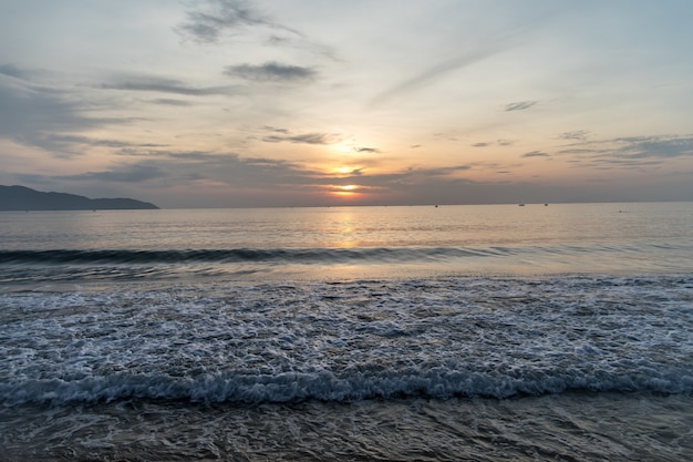 Oceano ondulado e sol poente