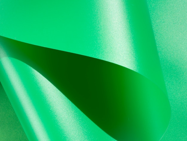 Foto grátis papel monocromático curvado abstrato verde do close-up