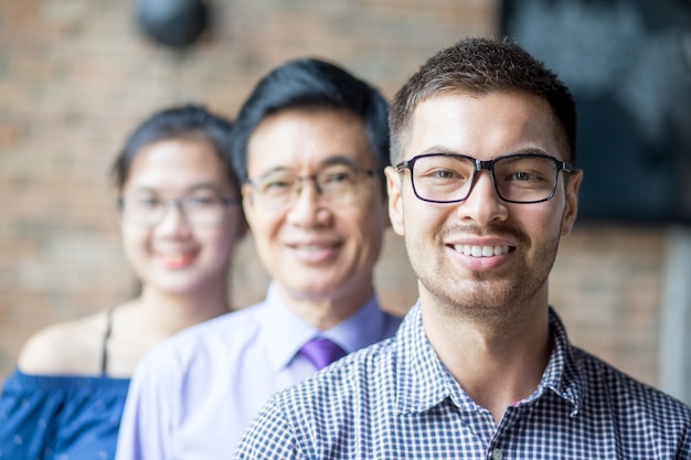 Foto grátis sorrindo equipe de negócios diversa em pé na fila