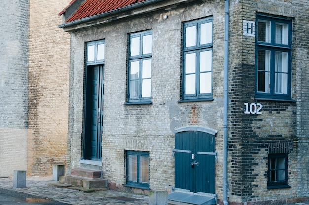 Kostenlose Foto altes ziegelsteinhaus auf gepflasterter straße