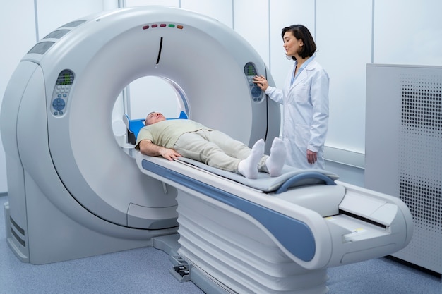 Kostenloses Foto arzt bereitet den patienten auf den ct-scan vor