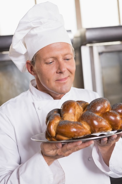 Baker que mostra o pão recém-assado