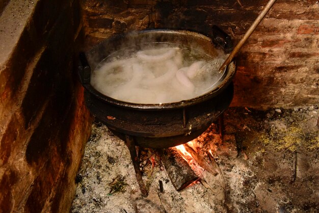 Cozinhar salsicha de sangue branco em uma panela de ferro em um fogão