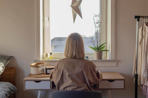 Escritório em casa pela janela A mulher freelancer trabalha