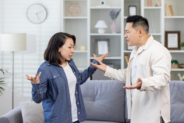 Foto familienstreit, asiatisches paar, mann und frau, die sich gegenseitig anschreien, familienkonflikt, asiaten zu hause