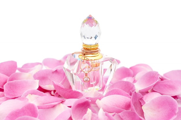 Foto frasco de perfume com colar entre pétalas de flores. perfumaria, cosméticos, coleção de fragrâncias