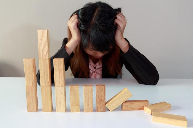 Foto frustrierte frau mit holzblöcken auf dem tisch