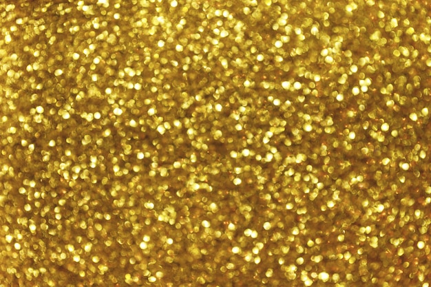 Fundo desfocado brilhante dourado com luzes cintilantes.