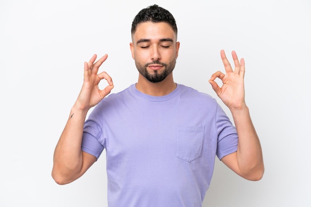 Homem bonito jovem árabe isolado no fundo branco em pose de zen