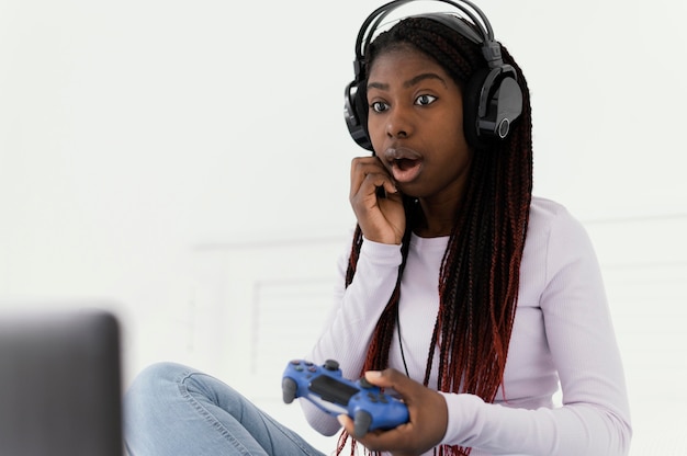 Menina com fones de ouvido jogando videogame