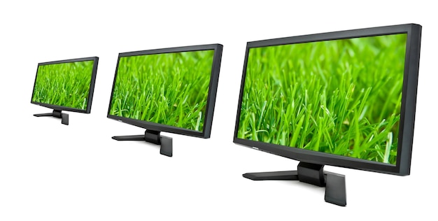 Foto monitores de tv lcd com grama verde na tela