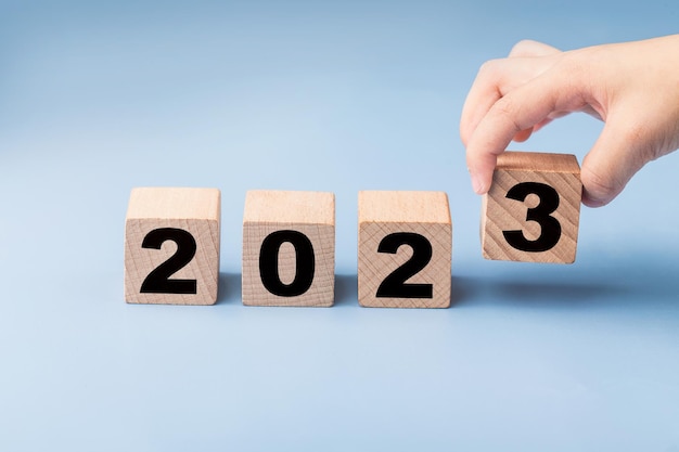 symbolisieren den wechsel von 2022 zum neuen jahr 2023. 2023 frohes neues jahr konzept.