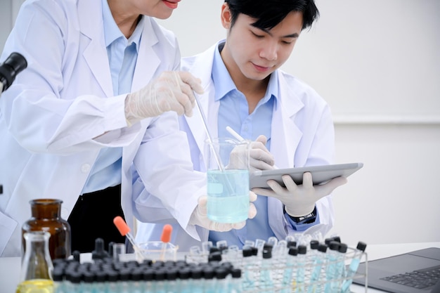 Um cientista masculino inteligente ou técnico médico trabalha com sua supervisora sênior