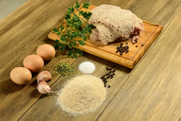 Vitela à milanesa apresentada na mesa com ingredientes