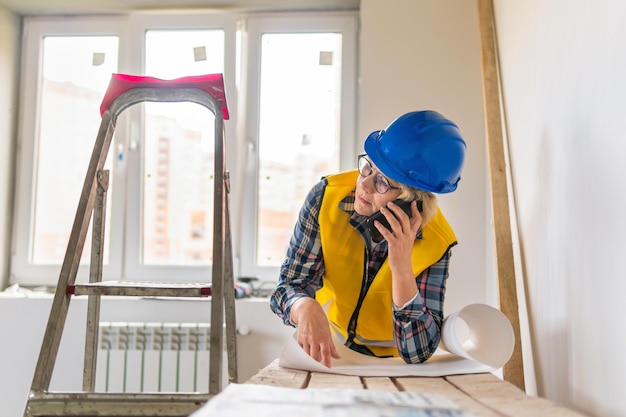 Woman Builder im Zimmer des Hauses, das Reparaturen durchführt.