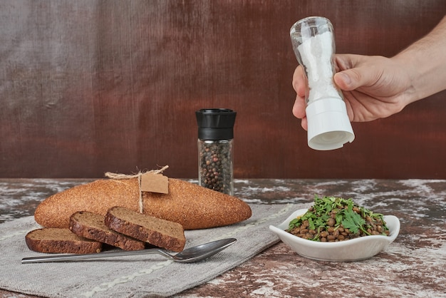 Free Photo adding salt into lentil salad.