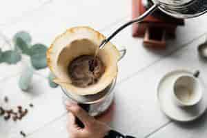 Free photo aerial view of a person making drip coffee