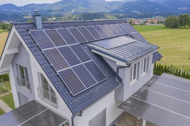 Free photo aerial view of a private house with solar panels on the roof