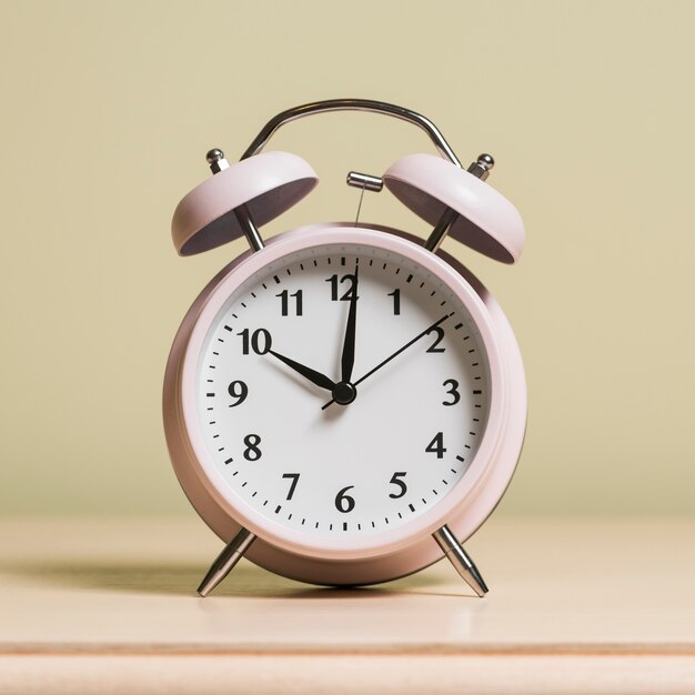 An alarm clock on wooden surface