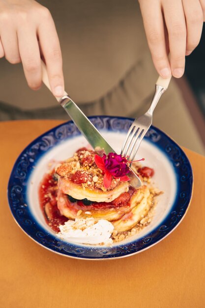 Appetizing pancakes decorated with berries and flowers