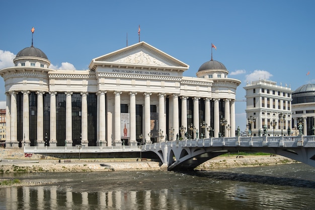 Free Photo archaeological museum of macedonia surrounded by a river with a bridge on it in north macedonia