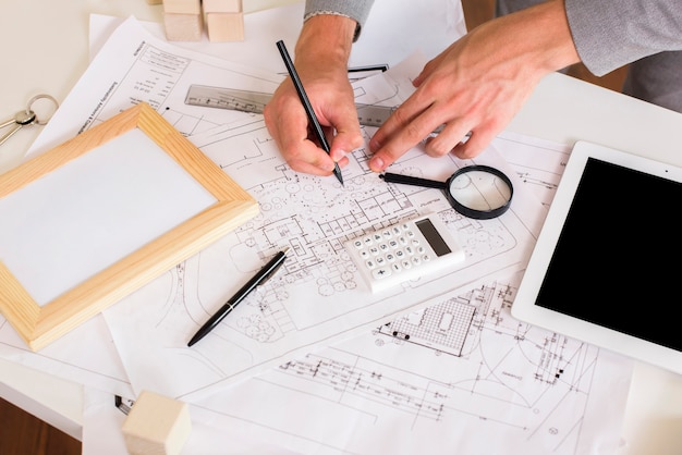 Free photo architect drawing a plan on paper mockup