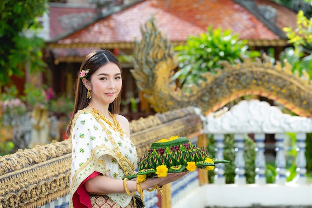 Free photo asia woman in thai dress traditional hold kratong loy krathong festival