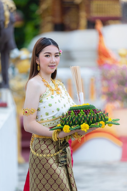 Free photo asia woman in thai dress traditional hold kratong loy krathong festival