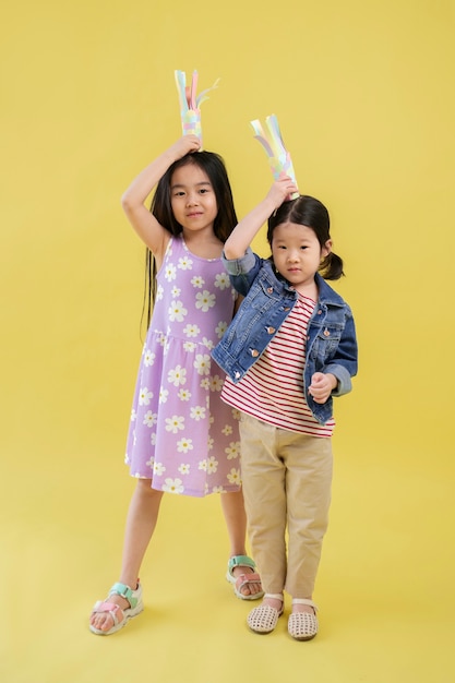 Free photo asian girl playing with paper fishes