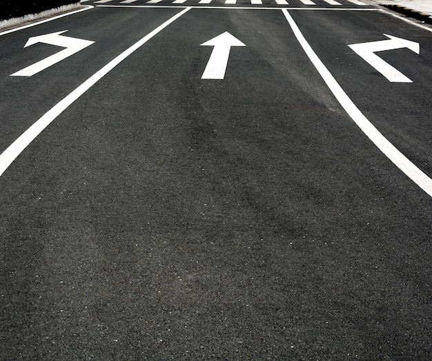 Free photo asphalt with different arrows