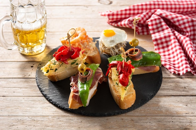 Assortment of Spanish pintxos on wooden table Typical spanish food