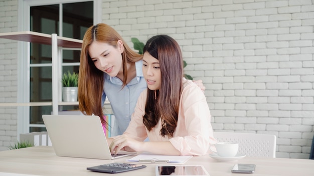 Free Photo attractive smart creative asian business women in smart casual wear working on laptop while sitting 