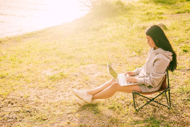 Free Photo attractive woman working remotely outdoors