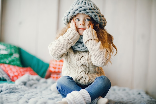 Free photo baby girl in knitted hat and scarf