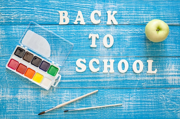 Free Photo back to school concept on wooden blue background top view