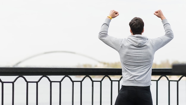 Free Photo back view fit athlete celebrating outdoors