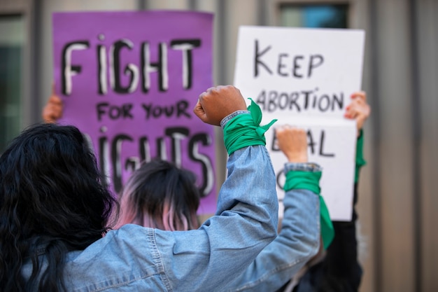 Free photo back view women protesting outdoors