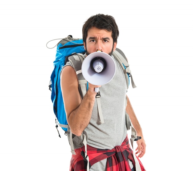 Free Photo backpacker shouting by megaphone over white background