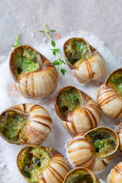 Free photo baked snails with garlic butter and fresh herbs