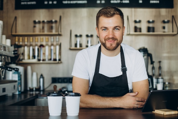 Barista standing by the counter in a coffee shop