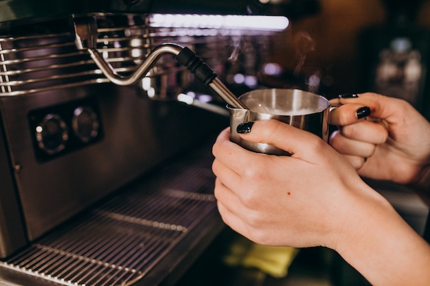 Free photo barista warming up coffee in a coffee machine