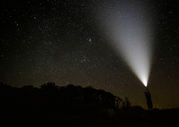 Beam of light in the starry night sky