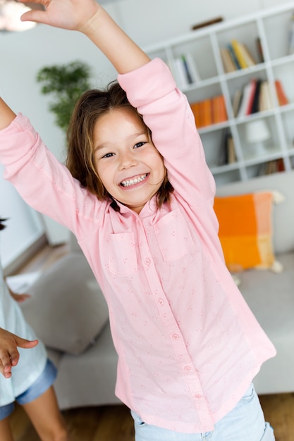 Free photo beautiful child listening to music and dancing at home.